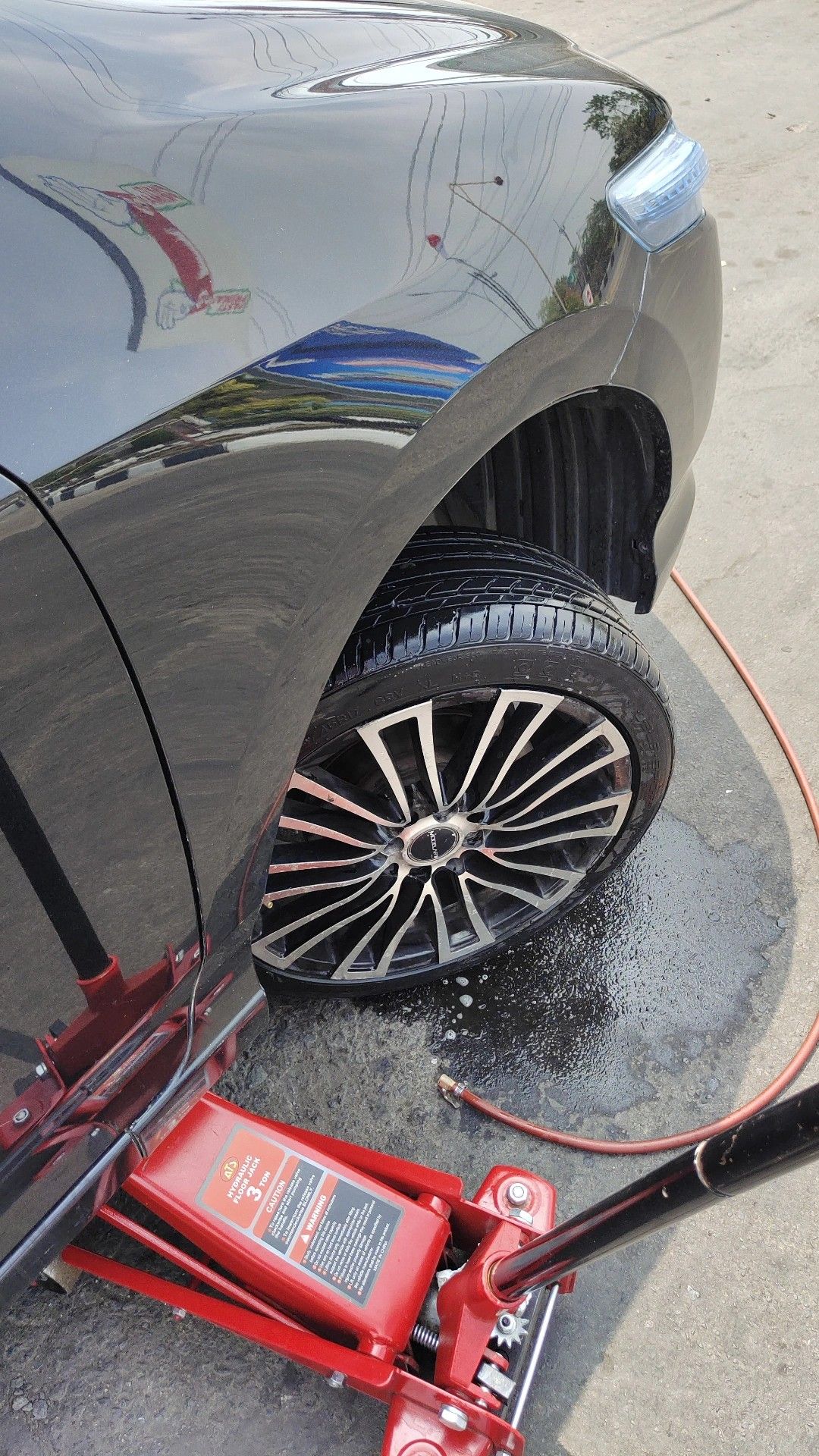 Mounting a wheel back on the car after a tire service