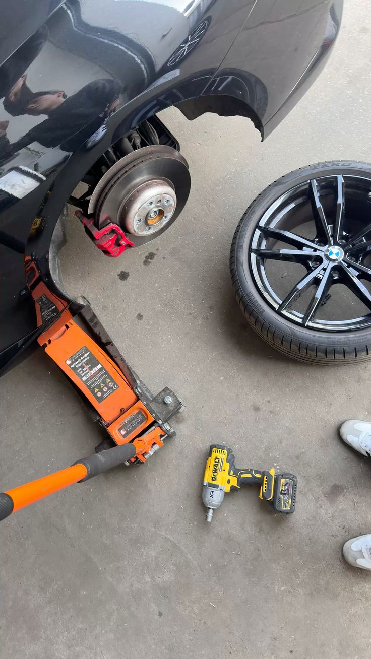 Removing a wheel with an impact wrench during a tire service