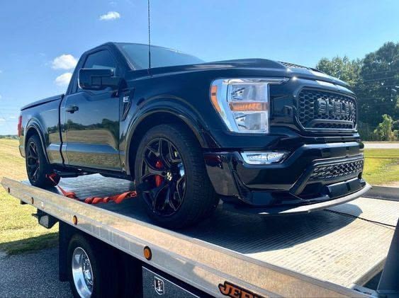 Pickup truck secured on a flatbed