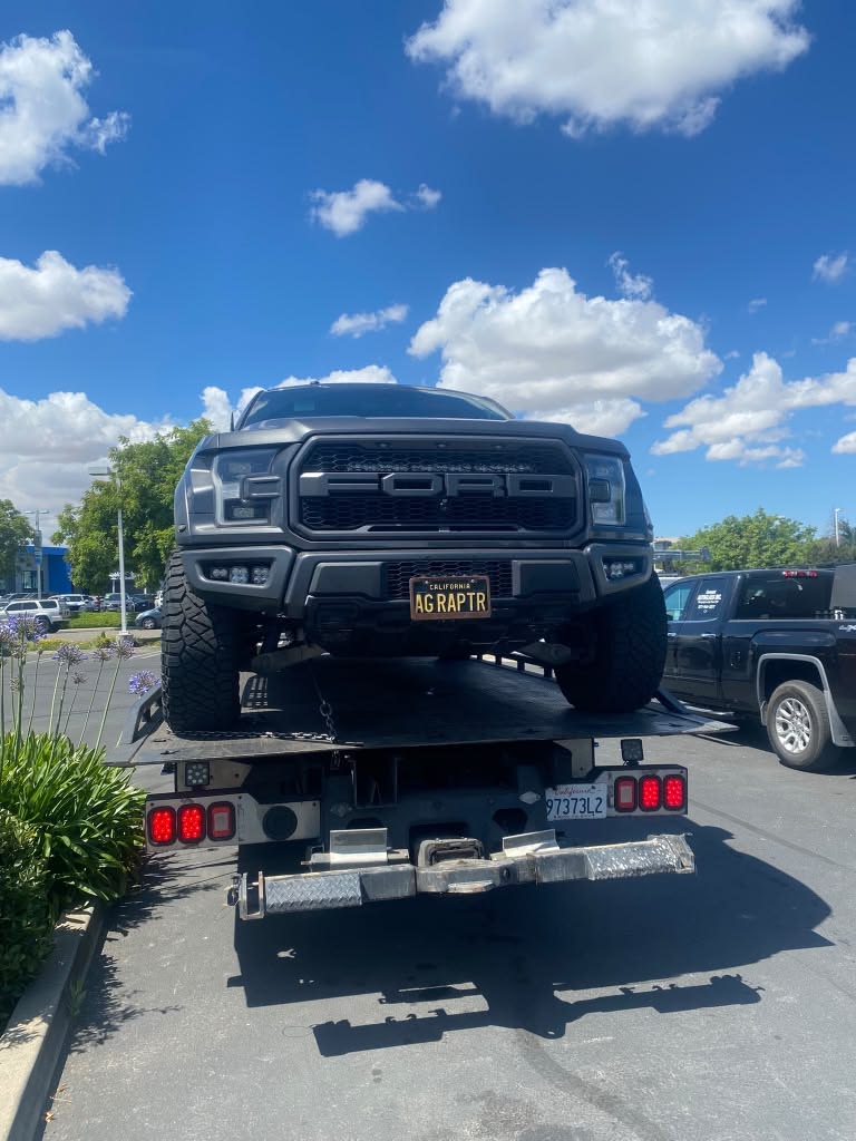 Truck loaded on a flatbed tow truck